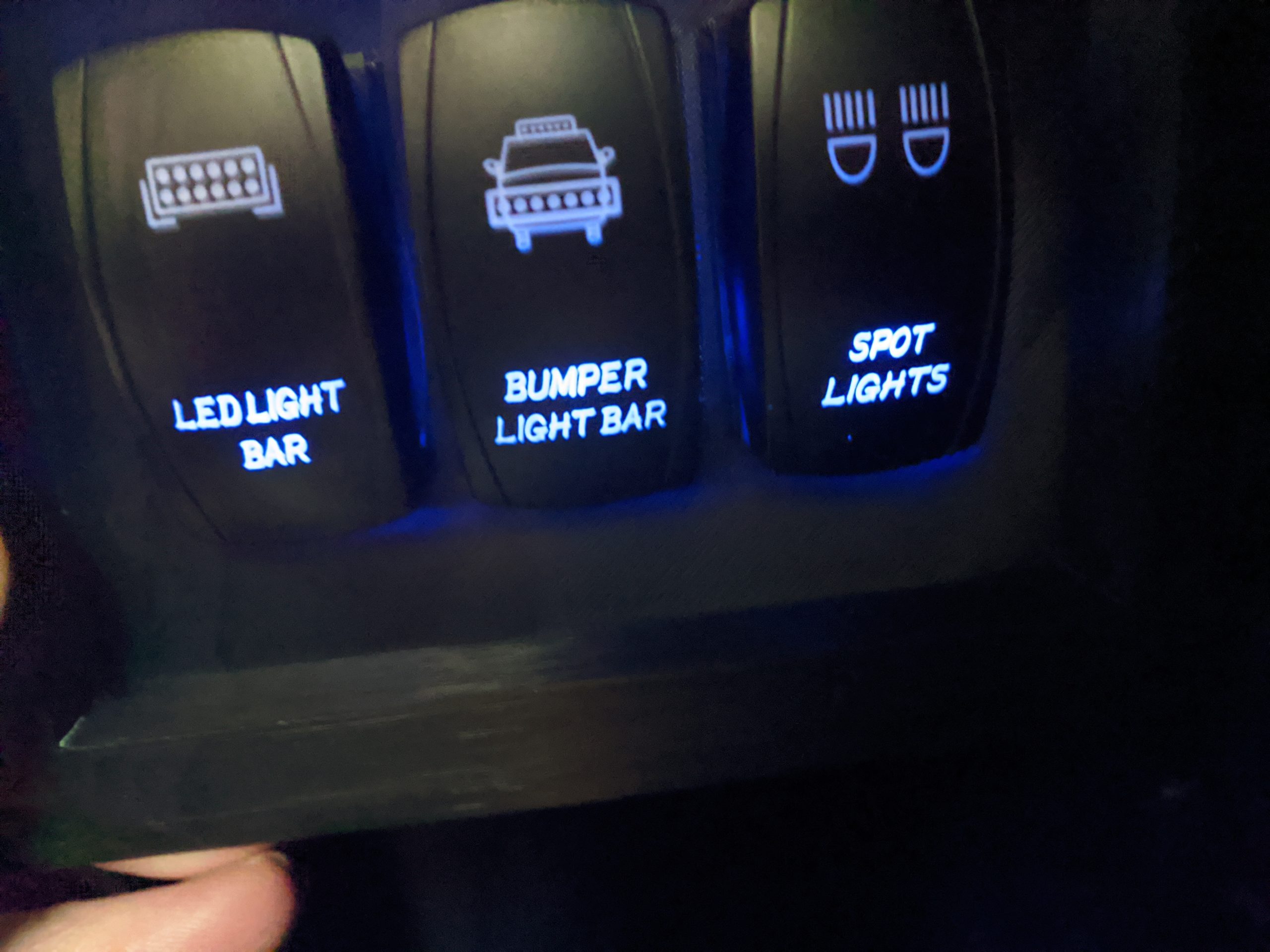 Switches light up on the bottom with key on, then light up on top when activated